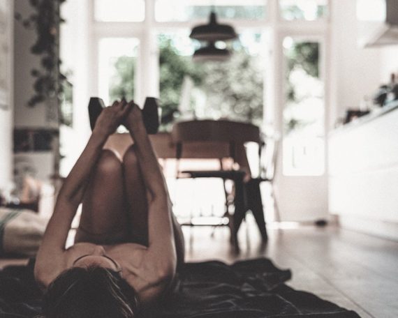 a woman laying on the floor in a kitchen
